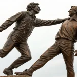 bronze statue joyful male figures